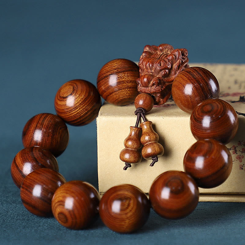 Multi-Wood Dragon Bracelet - Reddish-brown prayer beads with dragon head on vintage book, Protection
