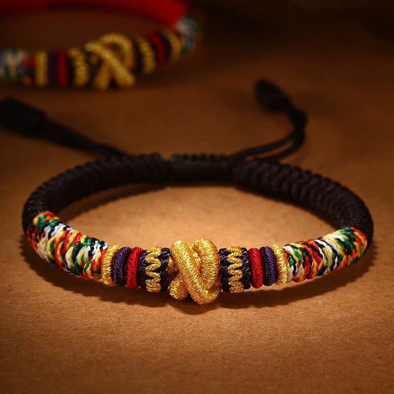 Tibetan Mantra Bracelet – Black cord with gold endless knot and rainbow woven sections, adjustable bracelet