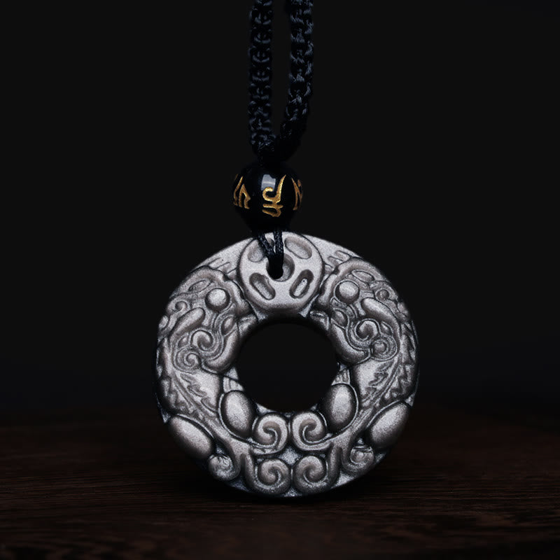 Silver Sheen Obsidian Double PiXiu Necklace – Obsidian PiXiu pendant with gold bead on dark wood, wealth jewelry