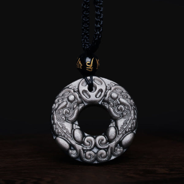 Silver Sheen Obsidian Double PiXiu Necklace – Obsidian PiXiu pendant with gold bead on dark wood, wealth jewelry