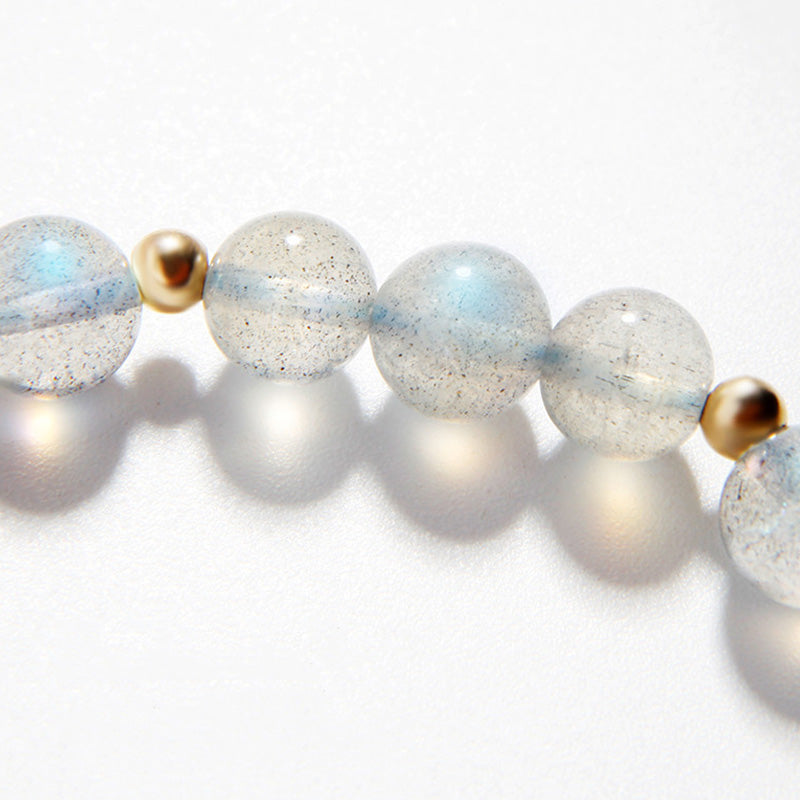 Moonstone PiXiu Bracelet – Close-up of iridescent moonstone beads with gold spacers on white