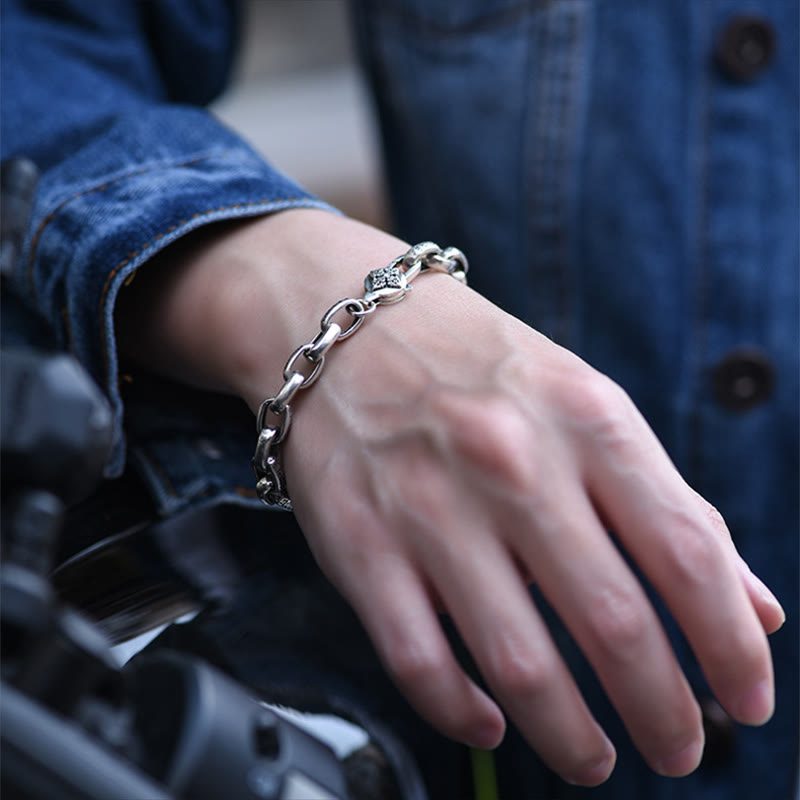 Double Dorje Wisdom Bracelet - Worn on wrist with motorcycle backdrop, leather sleeve lifestyle shot