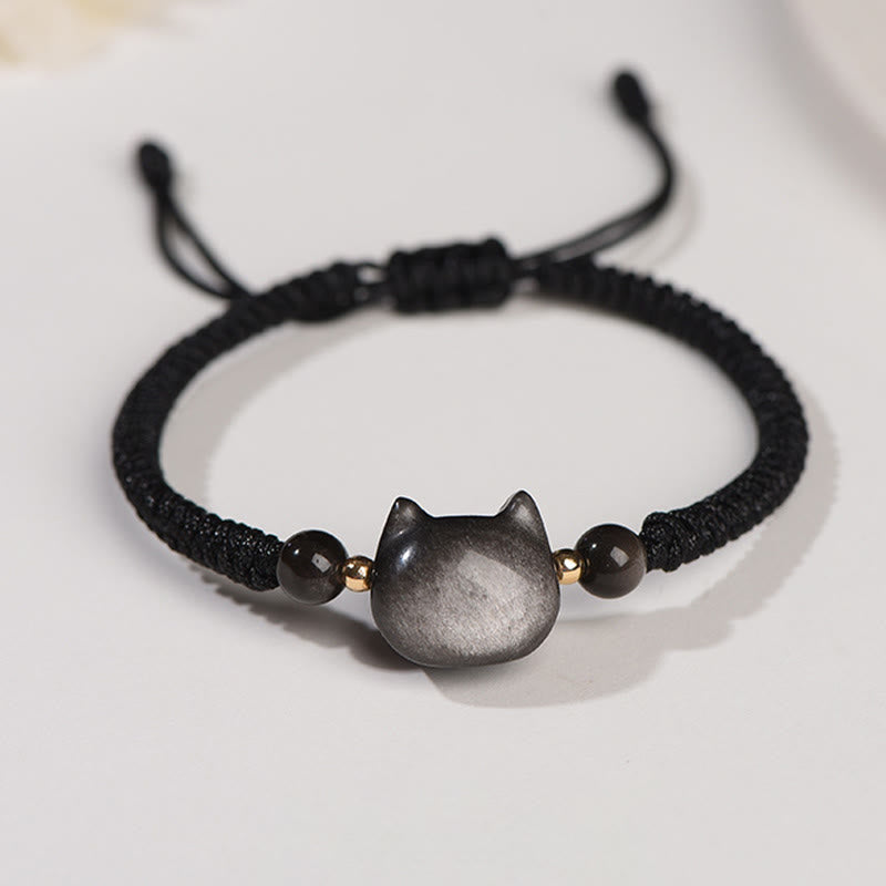 Silver obsidian cat head bracelet with black braided cord, gold spacer beads and adjustable drawstring closure, minimalist feline jewelry