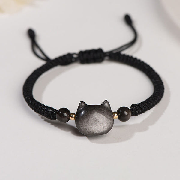 Silver obsidian cat head bracelet with black braided cord, gold spacer beads and adjustable drawstring closure, minimalist feline jewelry