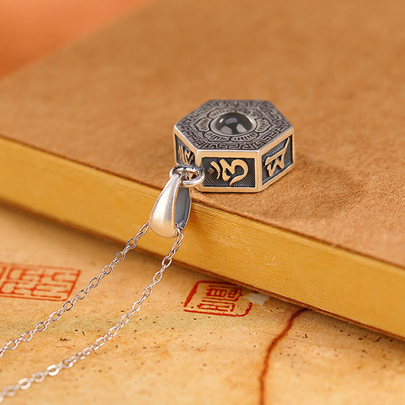 Om Mani Padme Hum Silver Necklace – Macro shot of hexagonal pendant with gold-accented script on leather