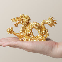 Golden Dragon Figurine - held in palm showing handheld scale, wealth charm, compact