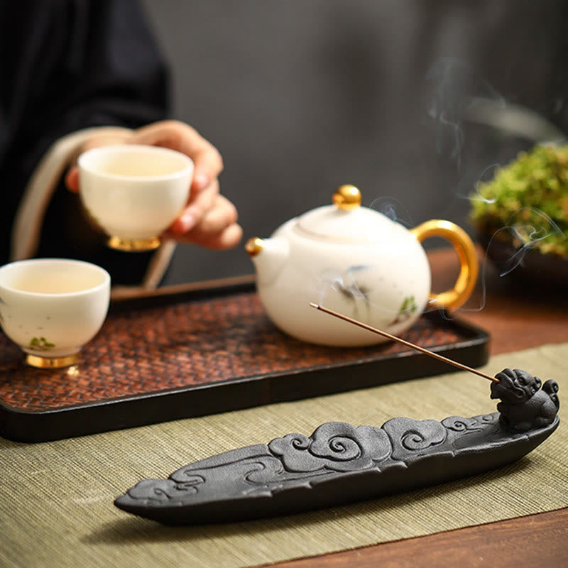 Pixiu incense burner with white gold-rimmed teapot and cups, smoke, sage mat, dark tray – ceramic incense holder for tea ceremony