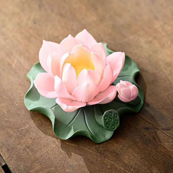 Lotus Ceramic Incense Burner - pink lotus bloom with bud and seed pod on wooden table, soft lighting
