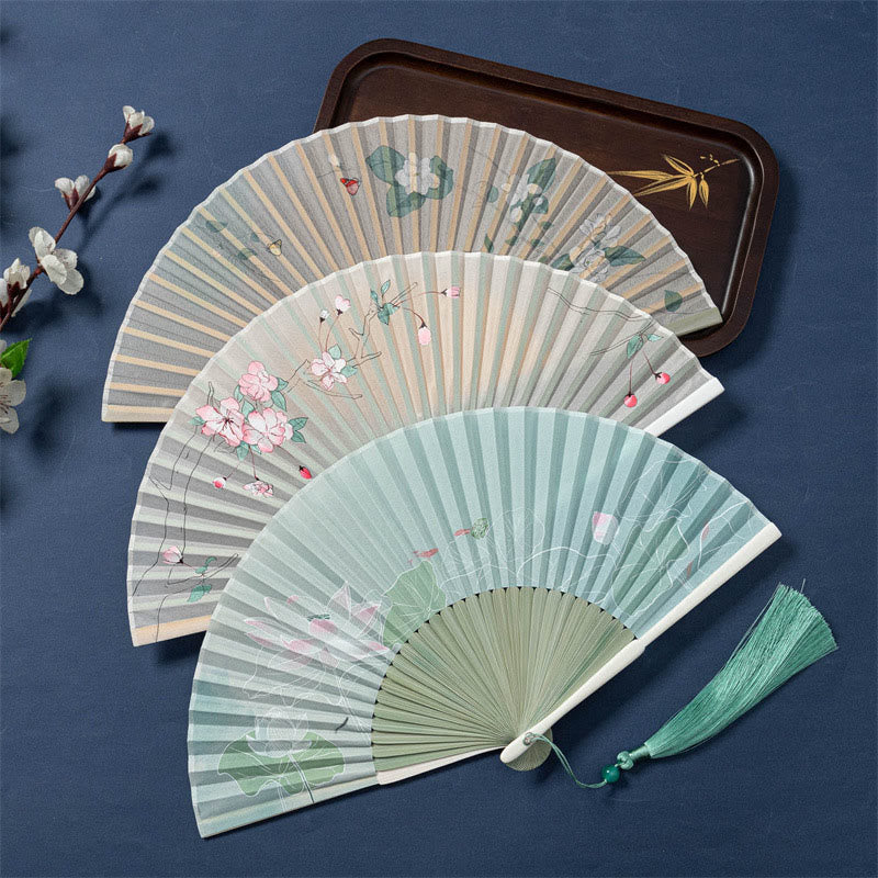 Lotus Begonia Jasmine Handheld Bamboo Folding Fan - three fans lotus begonia jasmine designs overlaid on navy