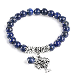 Tree of Life lapis lazuli bracelet with deep blue beads and golden pyrite flecks, silver tree-of-life charm, silver floral spacers, lapis dangle.