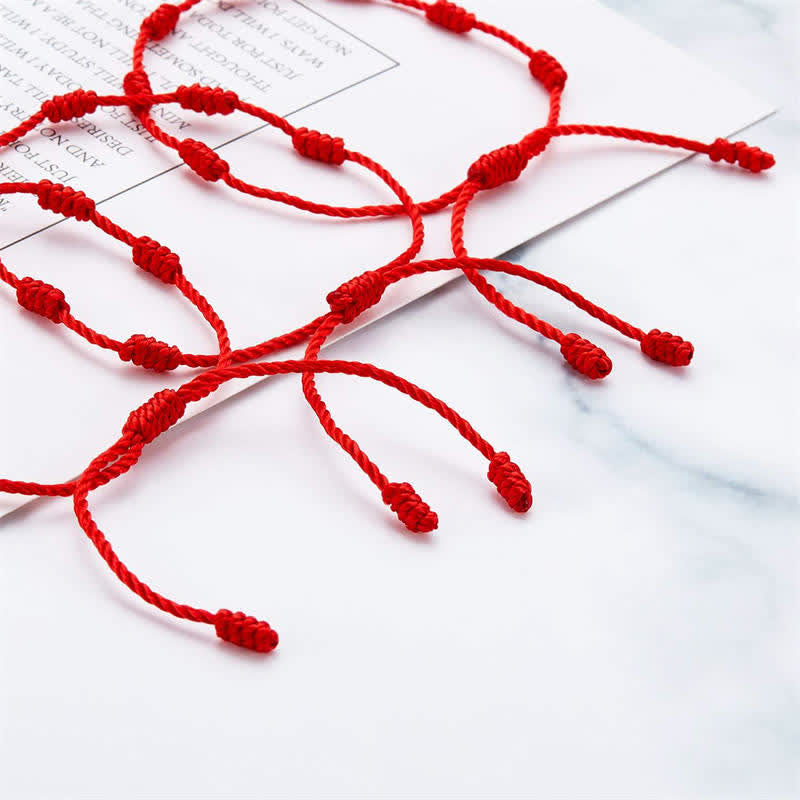 4Pcs Evil Eye Red String – Matching red string couple bracelets on clasped hands, romantic date setting