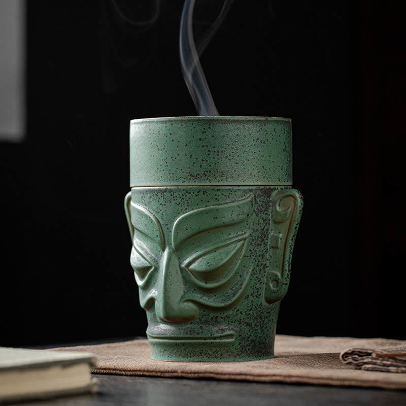Sanxingdui Bronze Mask Incense Burner – Three-quarter angle with smoke wisps on dark background, meditation decor