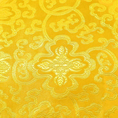 Tibetan Dragon Prayer Mat - Close-up golden brocade fabric with floral medallion and cloud scroll weave, Protection