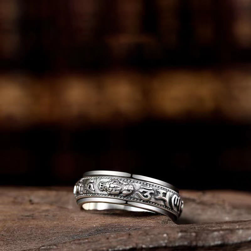 Tibetan PiXiu Ring – Side angle on rustic wood surface, meditation spinner ring