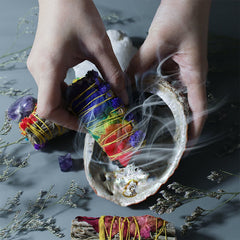Smudge Stick Set with Abalone Shell - Hands holding smoking stick over iridescent shell, ritual