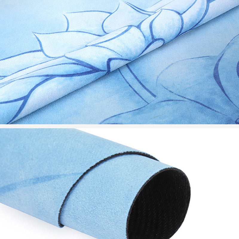 Lotus Mandala Yoga Mat – Folded fabric surface with blue lotus pattern, rolled mat revealing black foam core