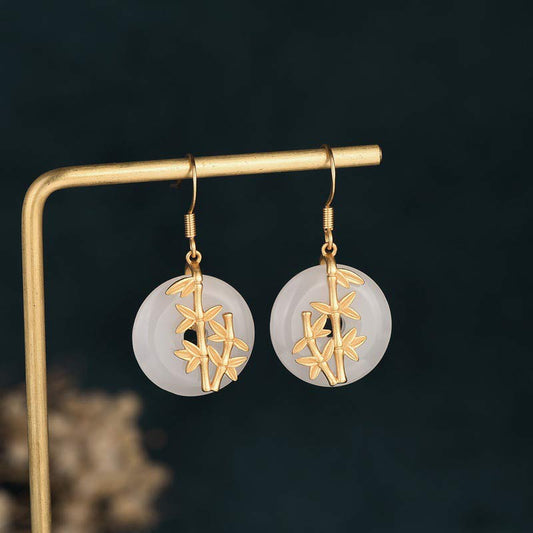 FengShui White Jade Fortune Earrings gold bamboo on display stand