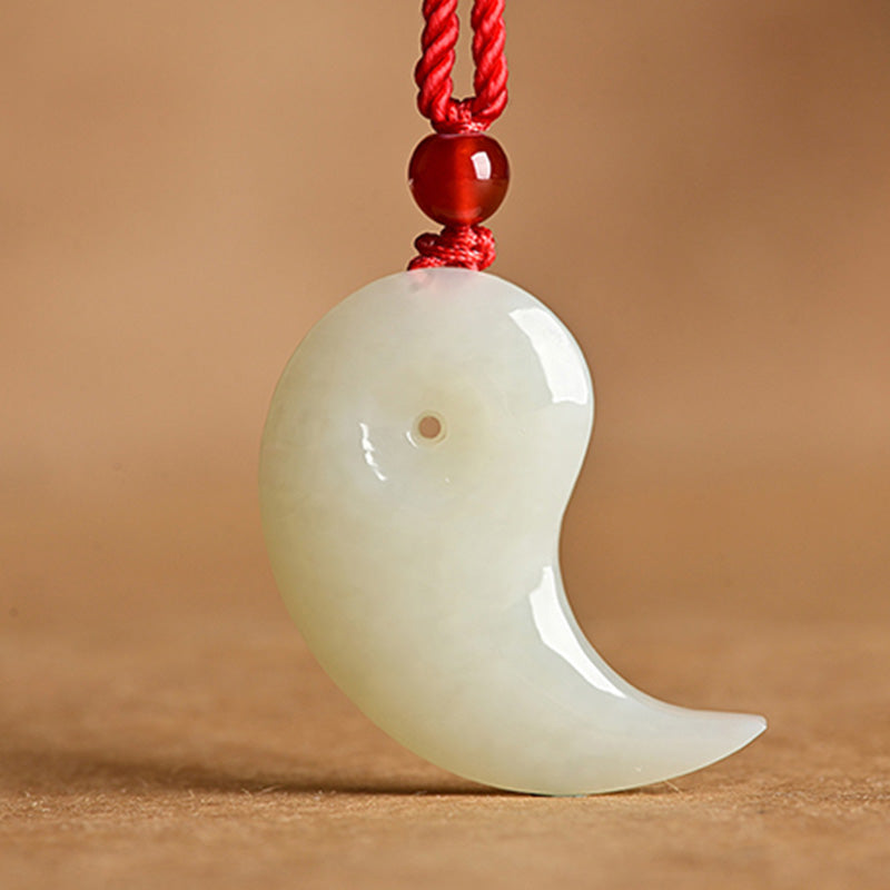 Yin Yang Jade Necklace – White jade magatama pendant on red braided cord with carnelian bead, kraft paper