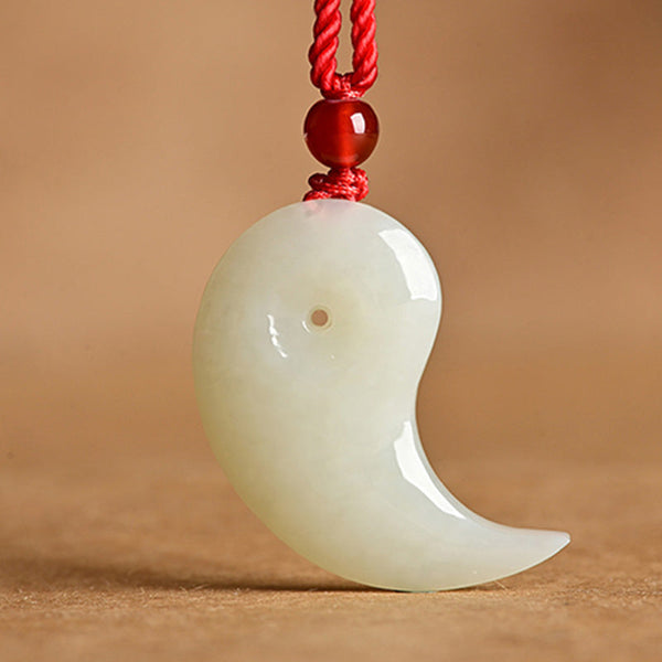 Yin Yang Jade Necklace – White jade magatama pendant on red braided cord with carnelian bead, kraft paper