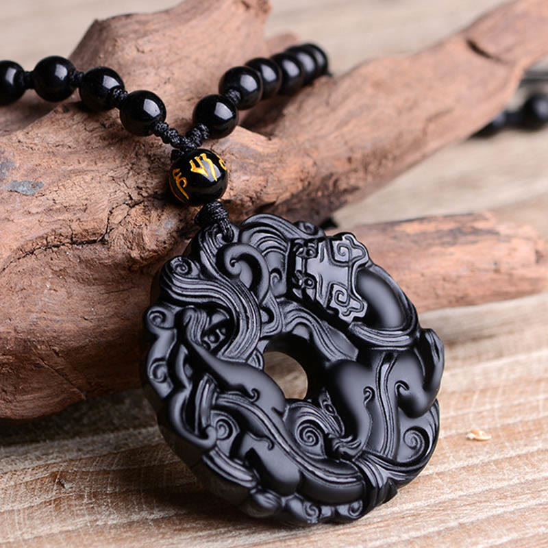Black Obsidian Pixiu Pendant – Carved black obsidian on textured wood, bead chain detail