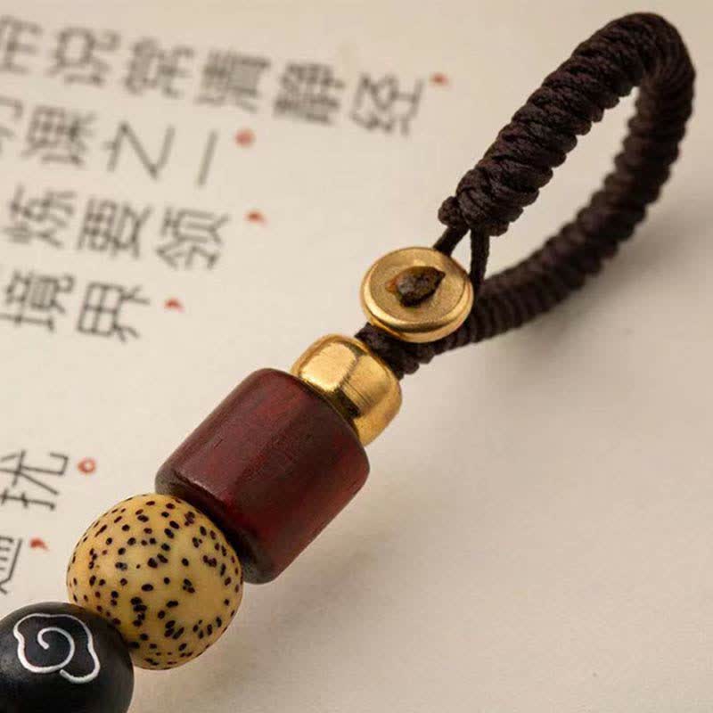 Pixiu Wealth Copper Key Chain – rope knot and beads close-up, brown cord with wood and black stone beads detail