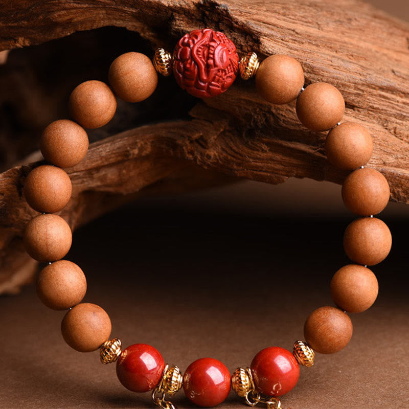 Peach Wood PiXiu Wealth Bracelet – Bracelet worn on wrist against black, peach wood cinnabar tassel jewelry
