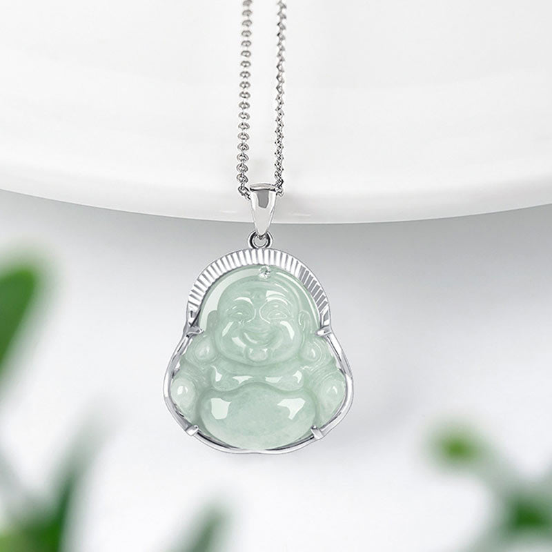 Jade Laughing Buddha Necklace - front view of carved green jade Buddha pendant on silver chain with botanical bokeh, calm