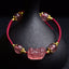 Strawberry Crystal PiXiu Charm Lucky Red String Bracelet – front view with pink crystal beads and gold spacers on black stand, feng shui good luck jewelry