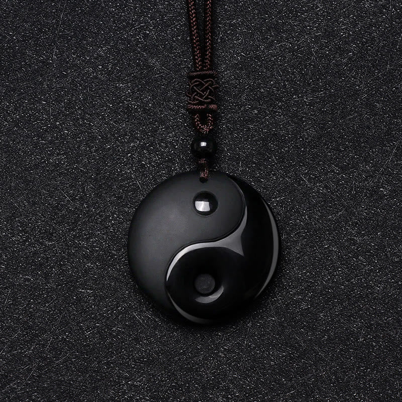 Black Obsidian Nine-Character Mantra Necklace – Yin-Yang obsidian amulet with knot detail, dark studio photography