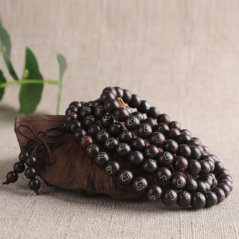 Sterling Silver Sandalwood Mantra Bracelet – coiled prayer beads with silver inlay on styled stand, wooden mala