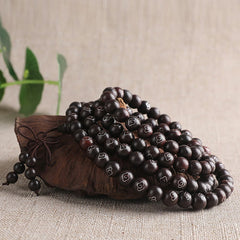 Sterling Silver Sandalwood Mantra Bracelet – coiled prayer beads with silver inlay on styled stand, wooden mala