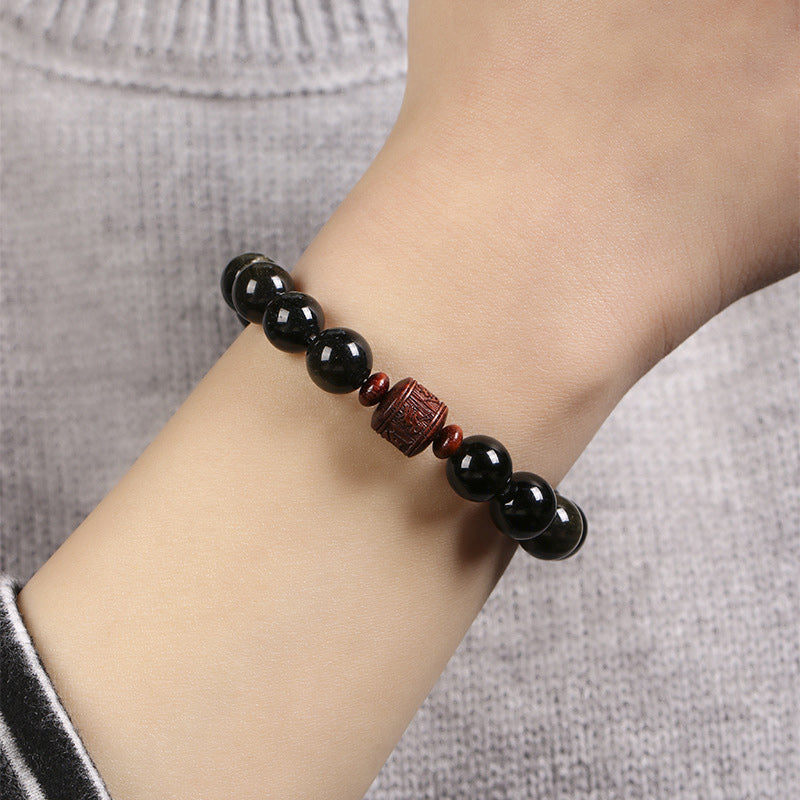Gold Sheen & Rainbow Obsidian Fu Bracelet – worn on wrist with gray sweater, obsidian bracelet
