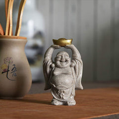 Laughing Buddha Resin Statue - gray speckled Buddha with gold ingot, lotus vessel nearby, Serene