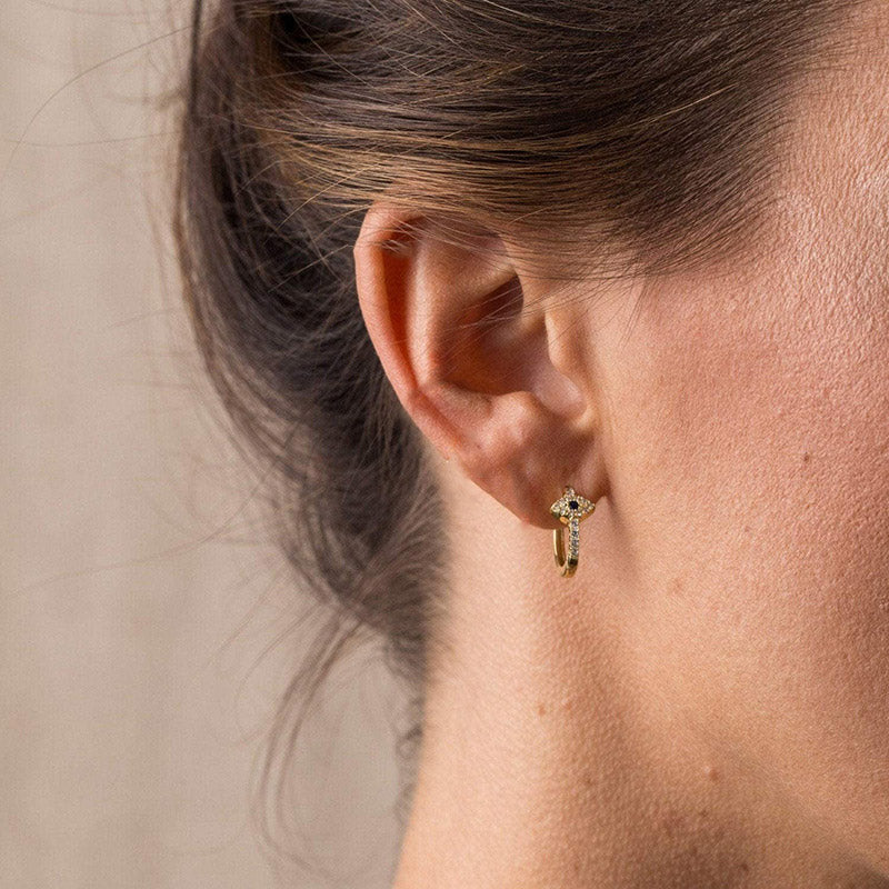 Evil Eye Stud Earrings – Gold huggie hoop with pave star charm, blue center stone, on ear