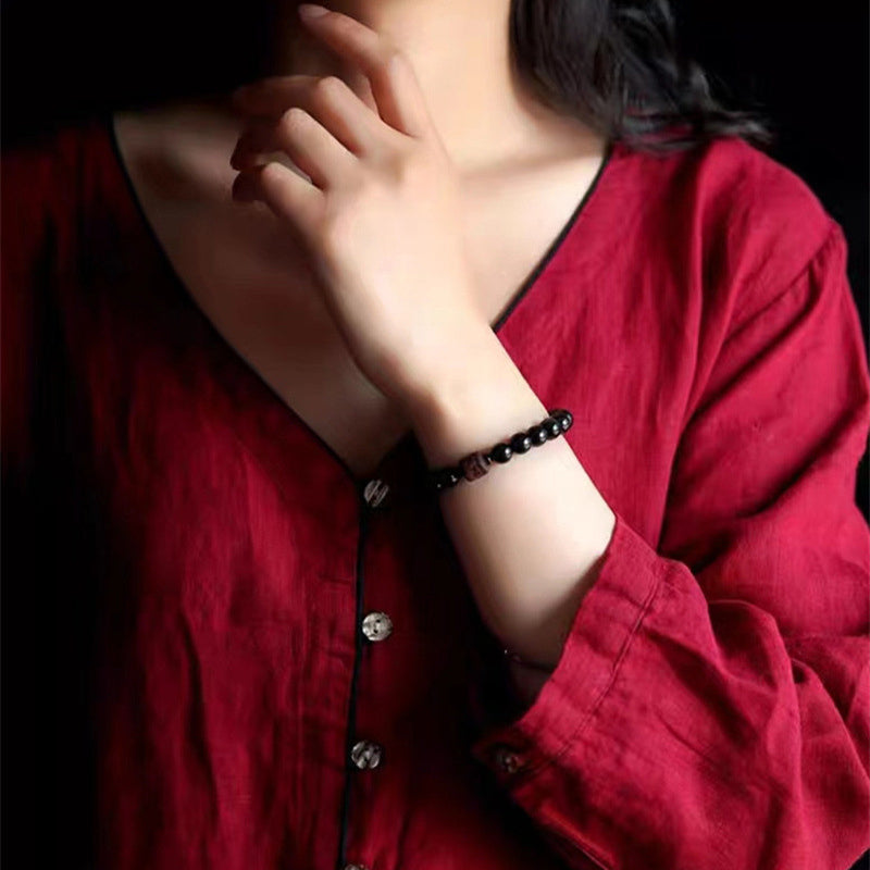 Gold Sheen & Rainbow Obsidian Fu Bracelet – worn with red garment, beaded fashion jewelry