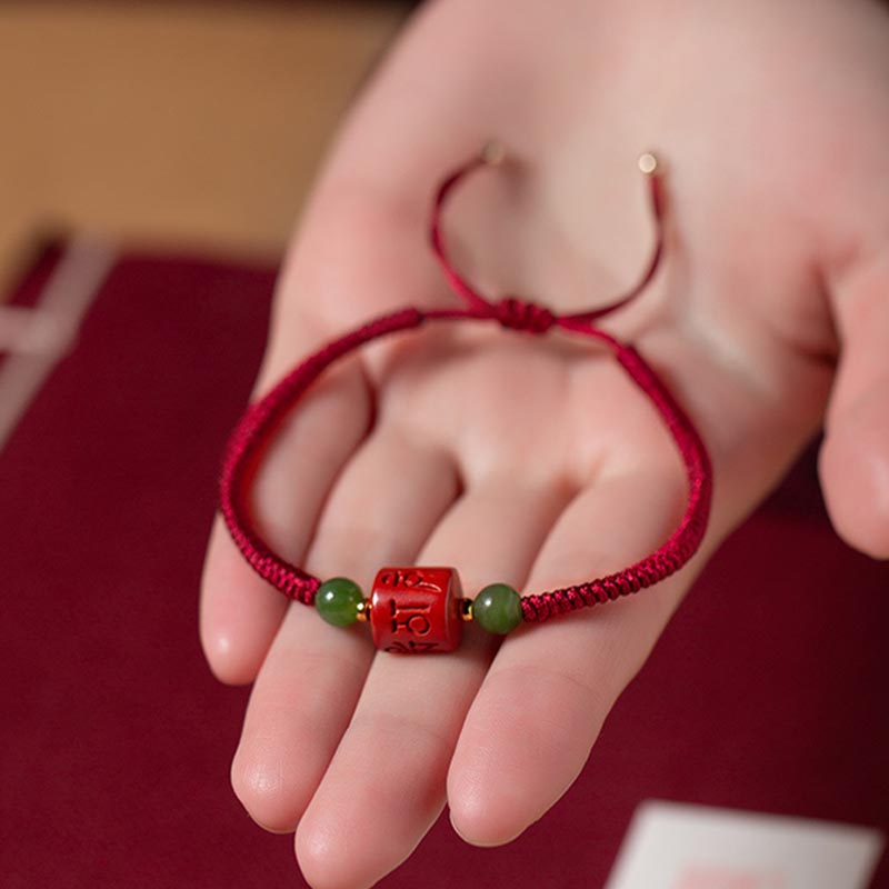 Tibetan Cinnabar Braided Rope Bracelet – Held on open palm showing adjustable knot and bead details