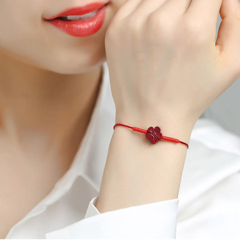 Cinnabar PiXiu Lotus Koi Fish Blessing Braid Bracelet – model wrist wearing red cord with cinnabar flower, everyday feng shui good luck wear