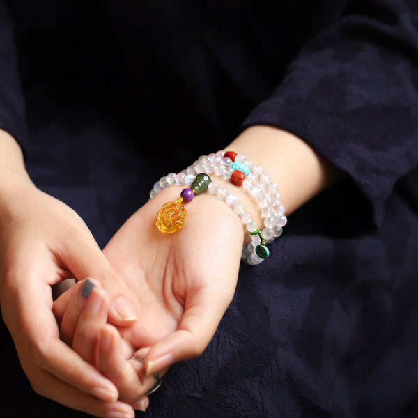 Moonstone Amber Turquoise Lotus Mala - Moonstone wrap bracelet with amber pendant worn on wrist, boho gemstone