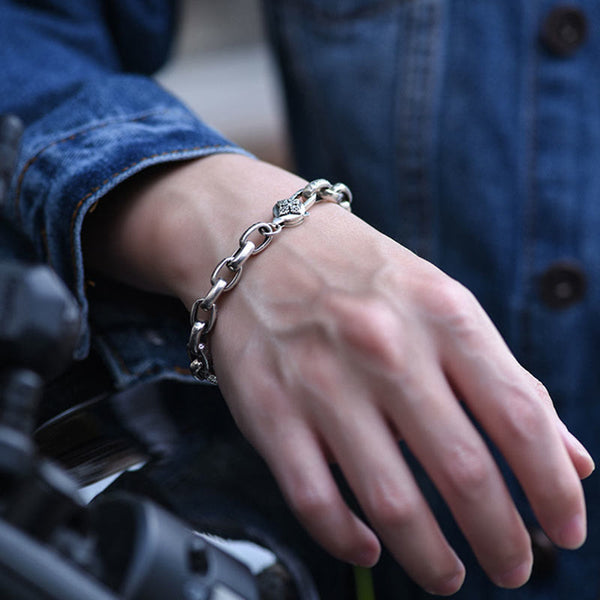 Om Mani Padme Hum Silver Bracelet – Worn on wrist with denim jacket and motorcycle, biker lifestyle shot showcasing silver chain