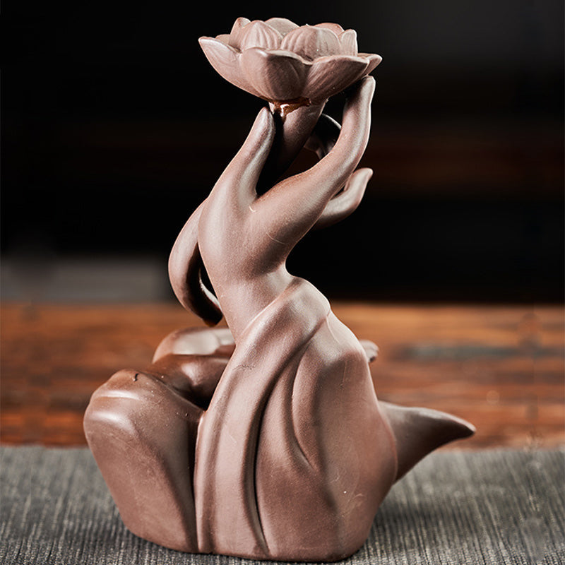 Lotus Bergamot Incense Burner – Terracotta mudra hands cradling lotus on gray fabric, healing decor