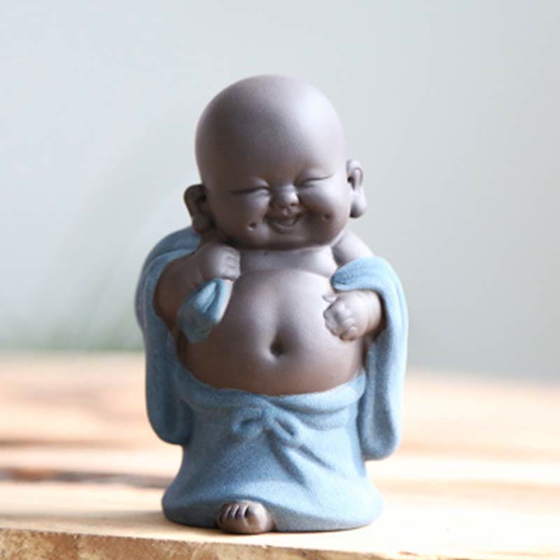 Laughing Buddha Purple Clay Maitreya Statue – seated Buddha in pale celadon-green robe with dark unglazed clay head, meditation hand position on dark surface