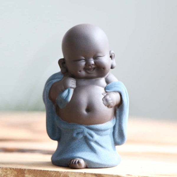 Laughing Buddha Purple Clay Maitreya Statue – seated Buddha in pale celadon-green robe with dark unglazed clay head, meditation hand position on dark surface