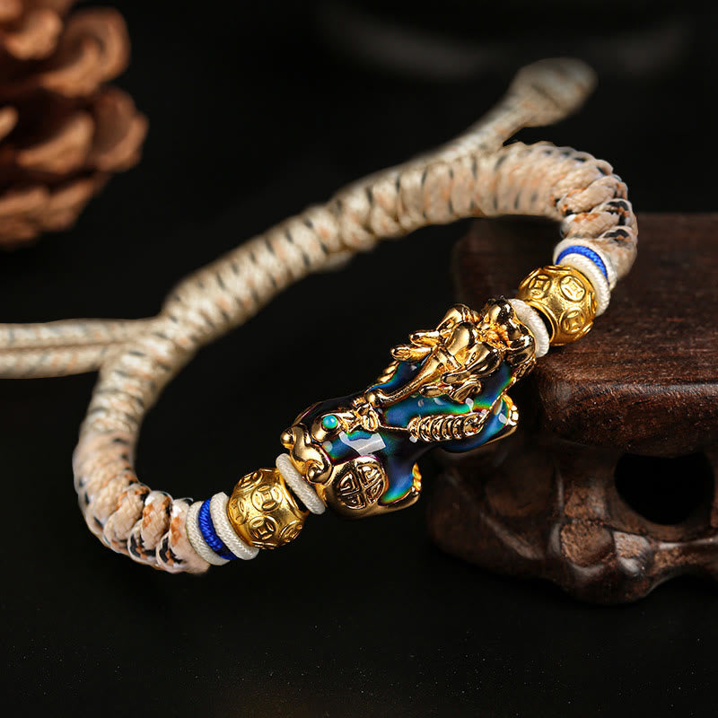 Feng Shui PiXiu Bracelet – color change Pixiu gold head blue body beige cord dark background, magic