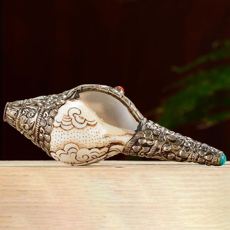 Engraved Shankha Positive Conch – monk robes draped behind conch display, monastic authenticity scene