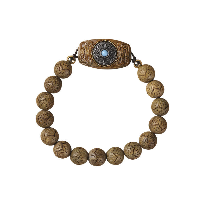 Green Sandalwood & Ebony Soothing Bracelet – flat lay on white background, intricate lotus petal carvings and turquoise in...