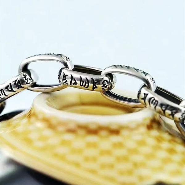 Double Dorje Wisdom Bracelet - Macro view of engraved script on chain links, Buddhist prayer bracelet