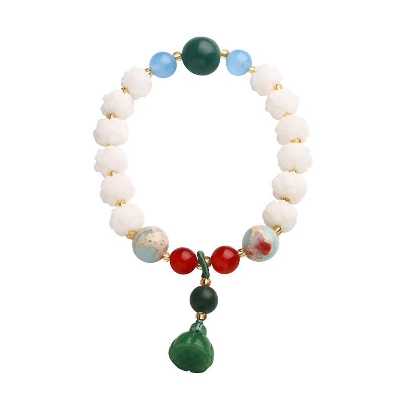 Carved Bodhi Seed Lotus Bead Peace Bracelet - white background with green lotus pendant, calm