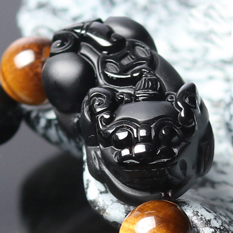FengShui PiXiu Rainbow Obsidian Bracelet – PiXiu carving extreme closeup, shiny black obsidian detail, tiger eye accent