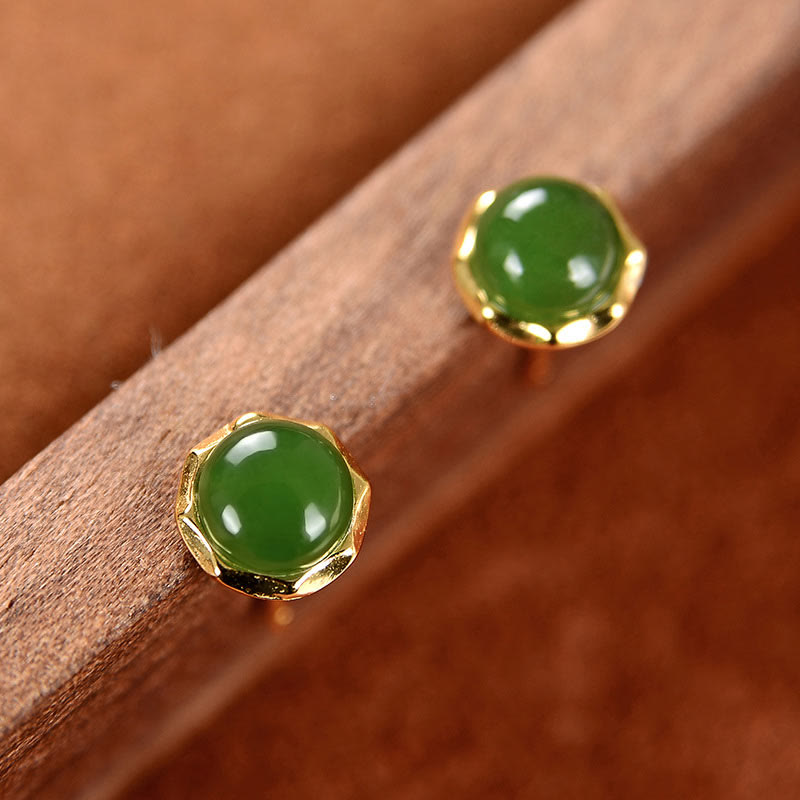 Hetian Cyan Jade Gold Plated Silver Stud Earrings angled view on wood