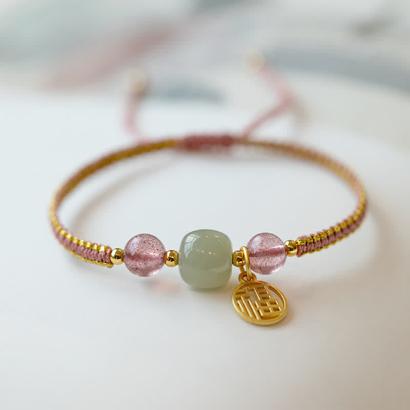 Red Agate Jade Lotus Bracelet – pink-purple cord with pink quartz and jade beads, Fu charm, manicured hand lifestyle close-up